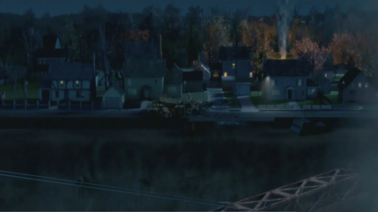 Monster House (2006) movie still: establishing — A quiet suburban street of detached houses is shown at night with scattered trees. Light from…