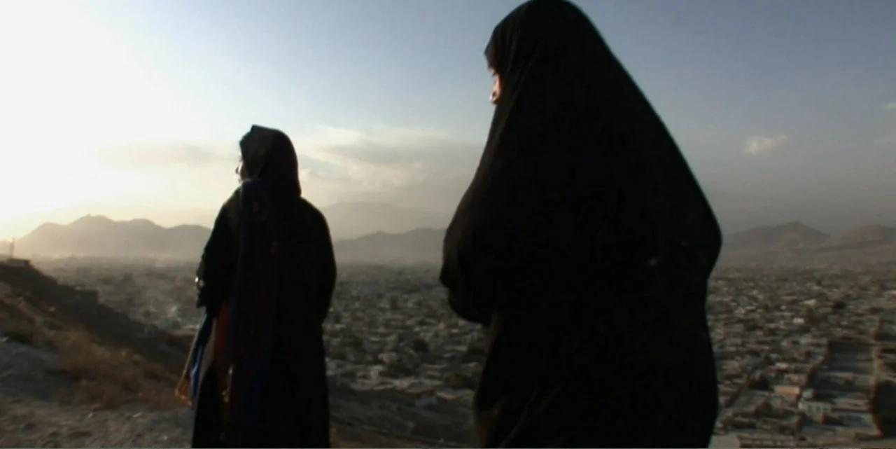 Silencing the Song: An Afghan Fallen Star (2011) movie still: medium — A dry, elevated hillside overlooks an expansive city stretching toward…