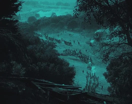 Birth of a Nation (1915) movie still: establishing — An expansive valley is filled with numerous soldiers moving through the darkness at night. The…