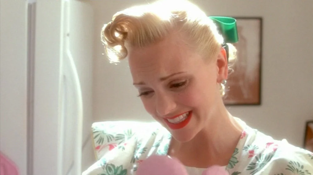 Smiley Face (2007) movie still: closeup — A 1950s style domestic setting with a plain wall and a white refrigerator background. A young woman with…