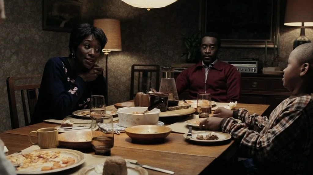 The Assassination of Richard Nixon (2004) movie still: medium — A wood-paneled dining room contains a wooden table cluttered with serving dishes and…