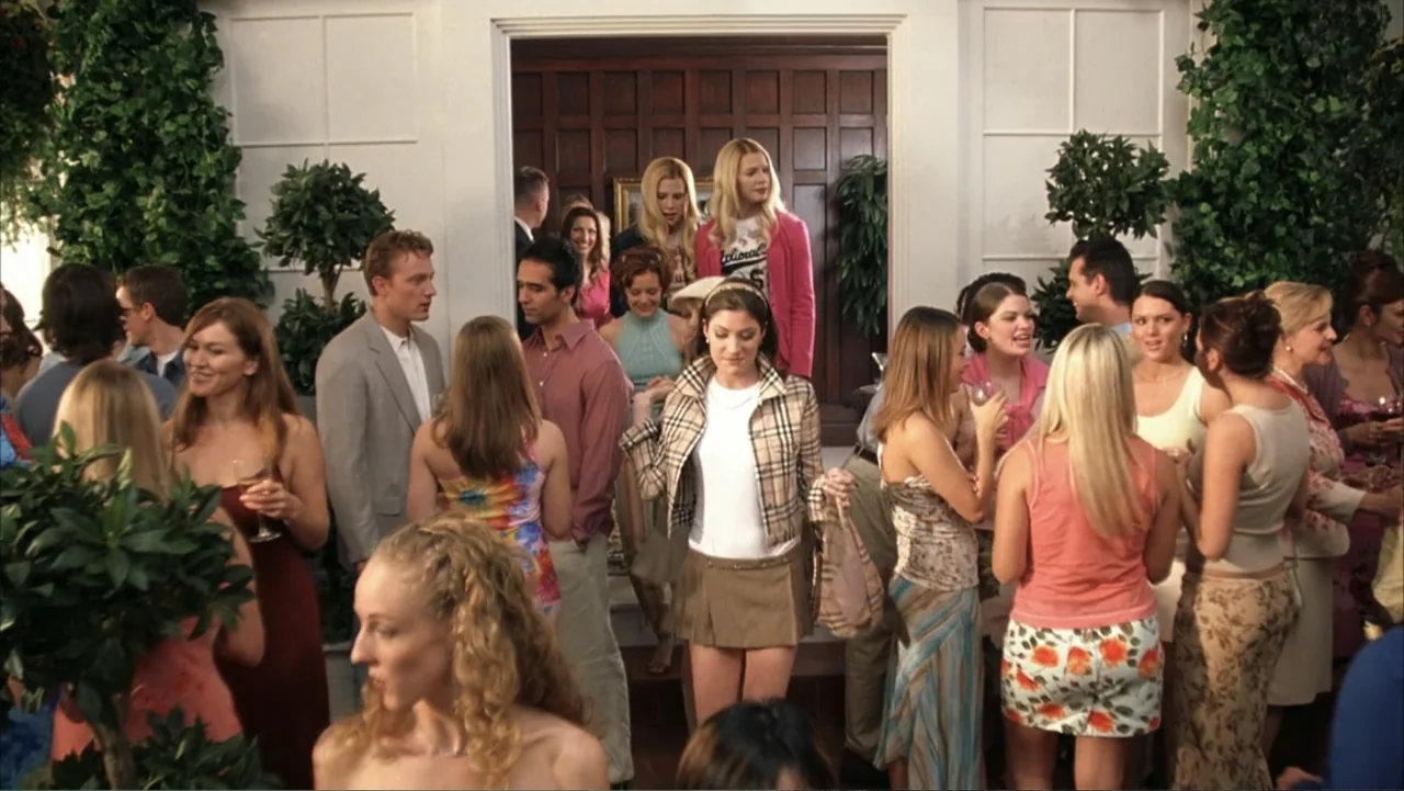 White Chicks (2004) movie still: medium — A crowded house party interior with white paneled walls and indoor greenery. Guests in 2000s attire…