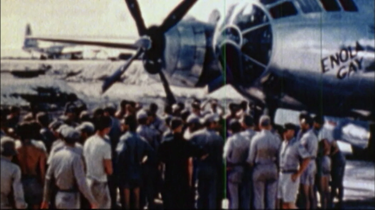 White Light/Black Rain: The Destruction of Hiroshima and Nagasaki (2007) movie still: wide — A sunny airfield tarmac features a large B-29 bomber…