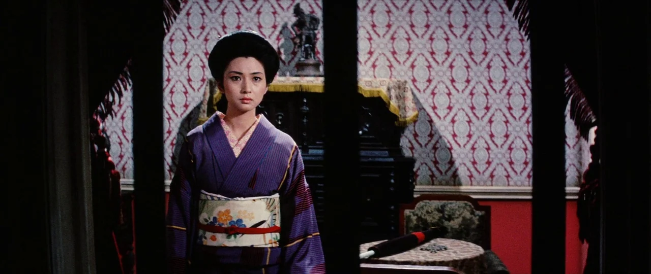 Lady Snowblood Song of Vengeance (1974) movie still: medium — A parlor features ornate red and white wallpaper and dark wooden furniture. A woman in…