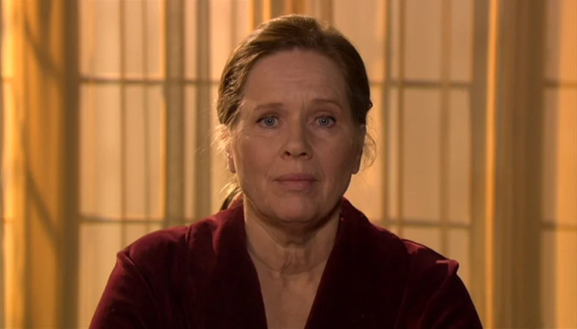Saraband (2003) movie still: medium — An interior space with a large window covered by light curtains. An older woman in a red velvet robe looks…