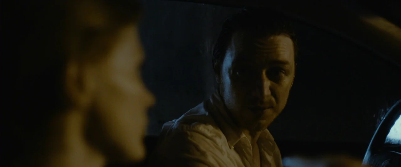 The Disappearance of Eleanor Rigby: Him (2014) movie still: medium — A dark, cramped interior of a moving car at night. A man turns his head to look…