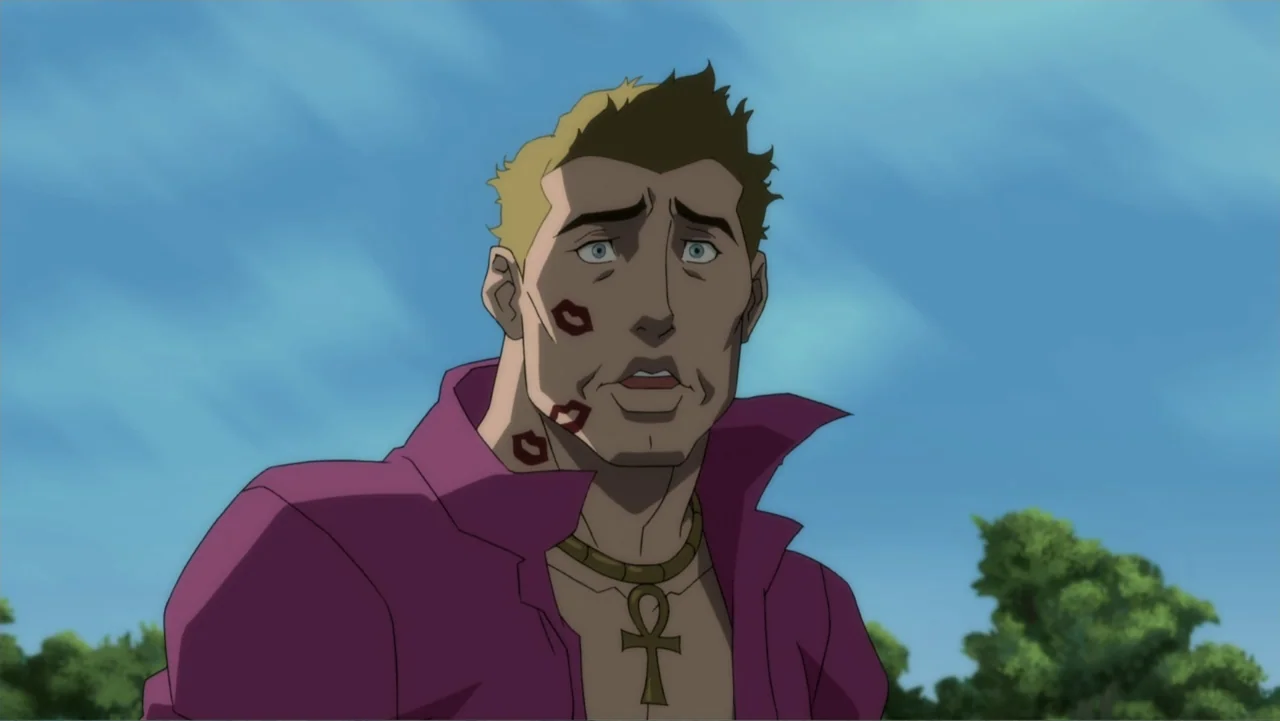 Suicide Squad: Hell to Pay (2018) movie still: medium — A man stands outdoors under a clear blue sky with green trees behind him. He is wearing a…