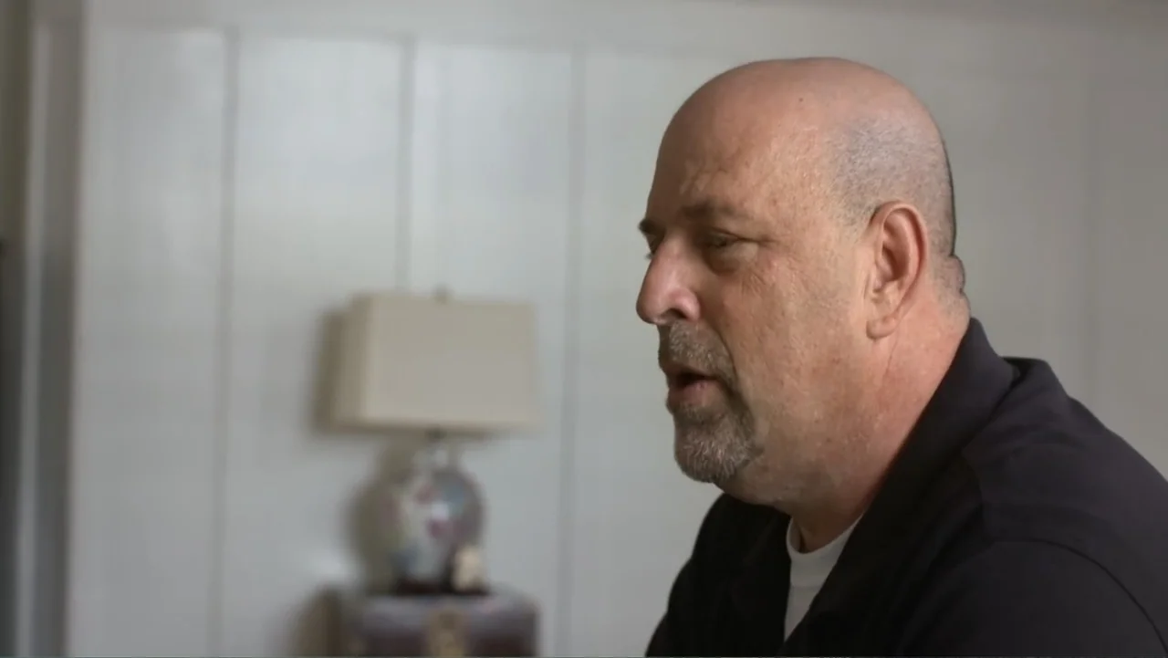 Homegrown: The Counter-Terror Dilemma (2016) movie still: closeup — A plain interior space features white paneled walls and a blurred table lamp. An…