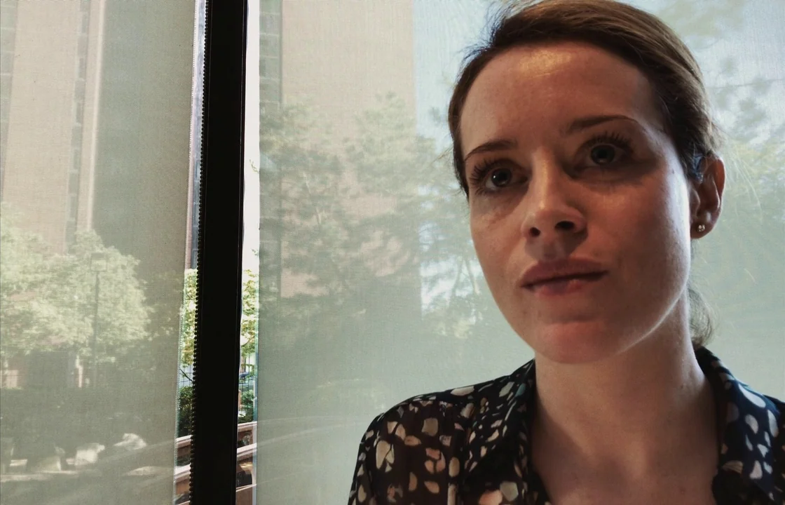 Unsane (2018) movie still: closeup — A woman stands indoors near a large window covered by a translucent white shade. Sunlight filters through the…