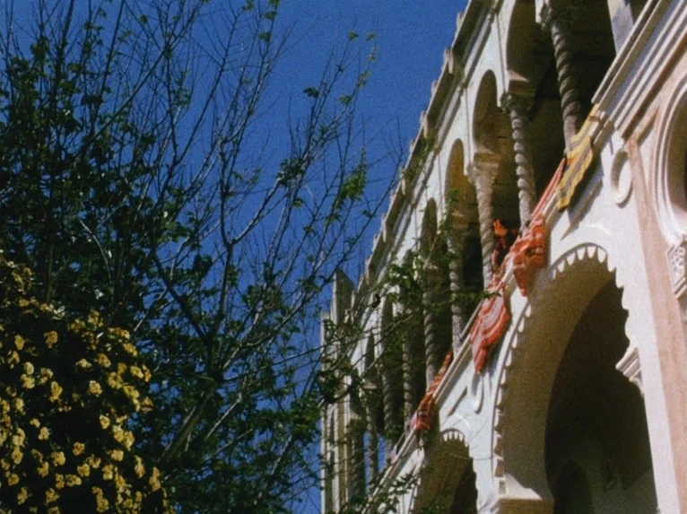 Our Lady of the Turks (1968) movie still: establishing — A Mediterranean-style building features stone arches and twisted columns against a bright…