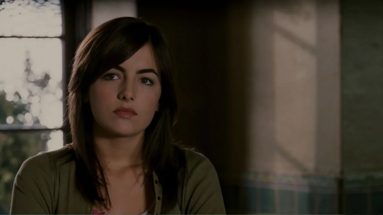 When a Stranger Calls (2006) movie still: medium — A woman sits indoors near a large window with soft natural light entering. The woman stares…