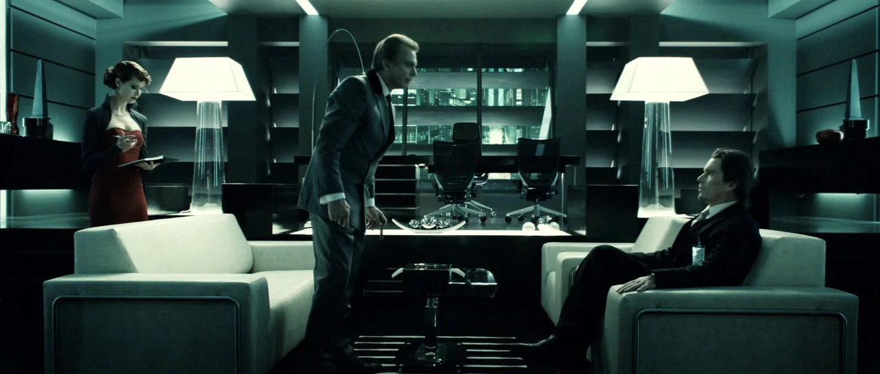 Daybreakers (2009) movie still: wide — A high-end modern office features minimalist white furniture, glass tables, and city night views. Three…