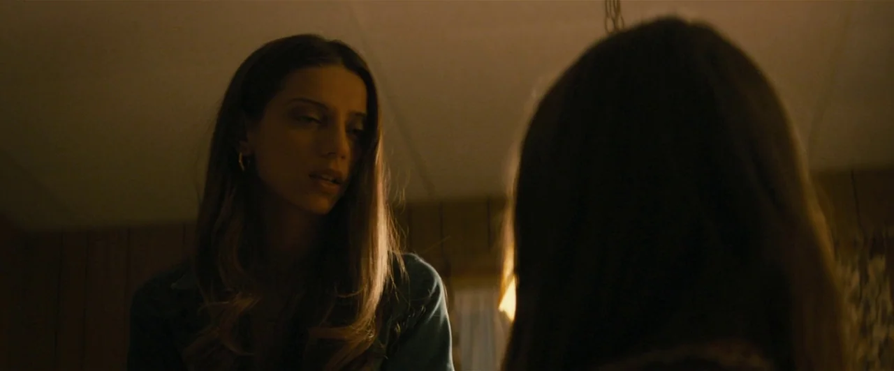 Extremely Wicked, Shockingly Evil and Vile (2019) movie still: medium — A dimly lit room features wood-paneled walls in a shadowed domestic…