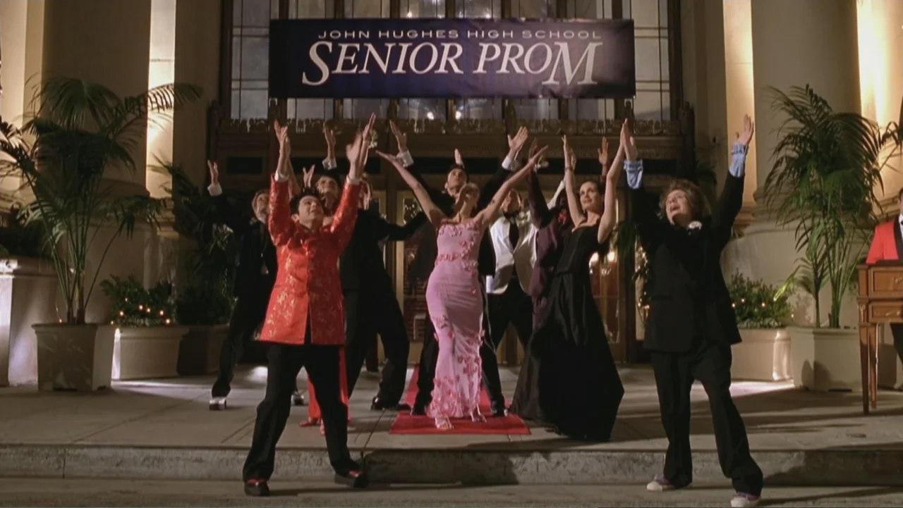 Not Another Teen Movie (2001) movie still: fullbody — A group of teenagers stands on a red carpet at the entrance of a building. They are…