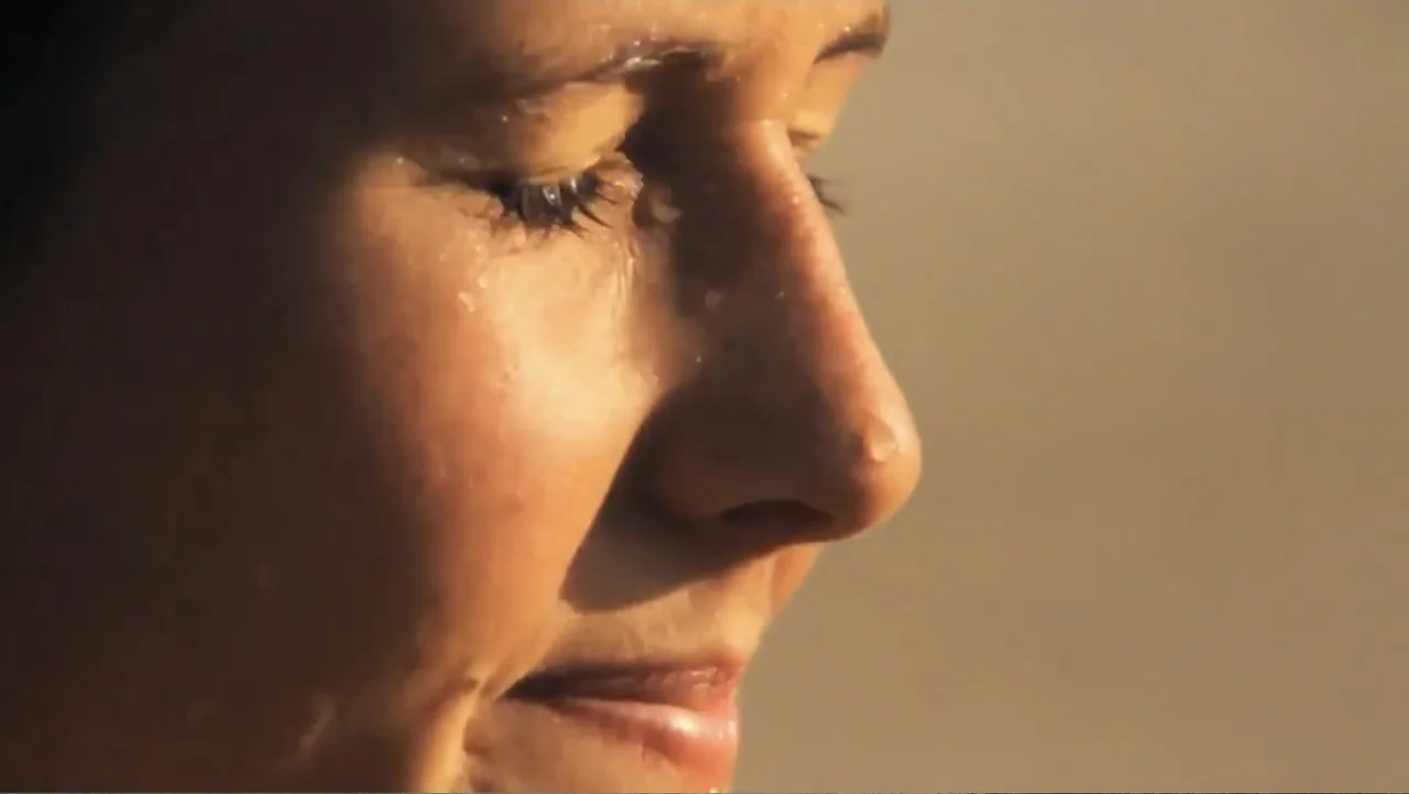 El sueño (2020) movie still: closeup — An exterior space is bathed in warm light during the late afternoon hours. A woman's face is shown in close…