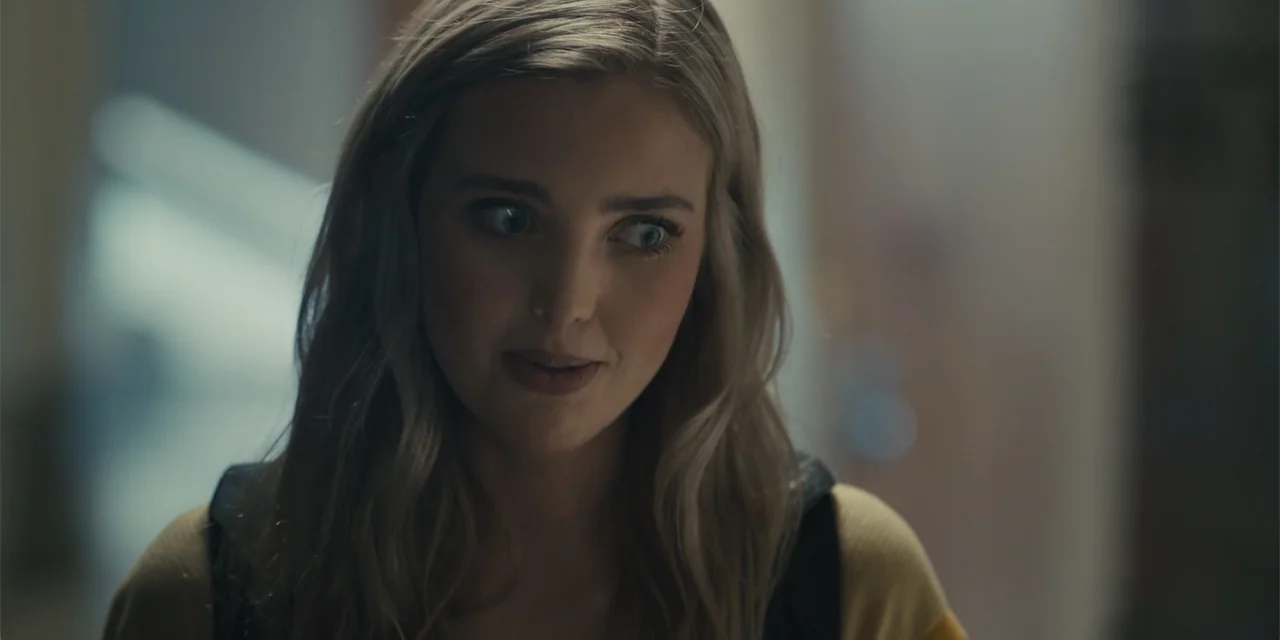 All Roads to Pearla (2019) movie still: closeup — A blurred indoor hallway with soft, diffused lighting creates an indistinct background. A young…