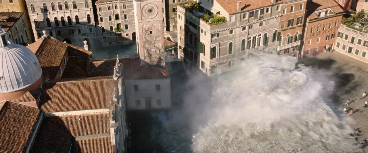 Spider-Man: Far From Home (2019) movie still: establishing — An aerial view captures a historic plaza in Venice being hit by a wave. Water surges…