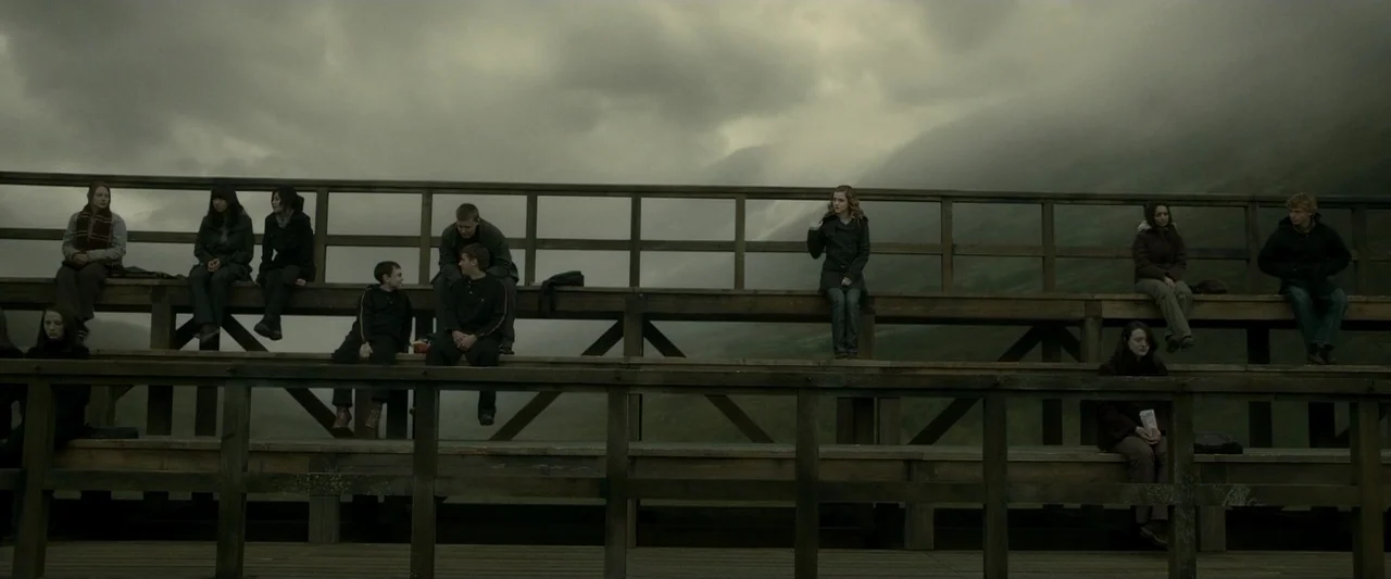 Harry Potter & The Half Blood Prince (2009) movie still: wide — A set of tiered wooden bleachers overlooks a misty valley under a clouded sky.…