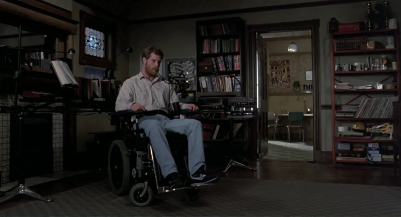 An Experiment in Fear: The Making of Monkey Shines (2014) movie still: medium — A study room features dark bookshelves, wooden furniture, and a door…