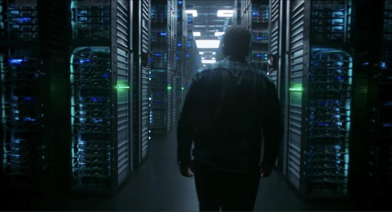 Space Jam: A New Legacy (2021) movie still: medium — A high-tech facility filled with rows of illuminated server racks in a dark environment. A man…