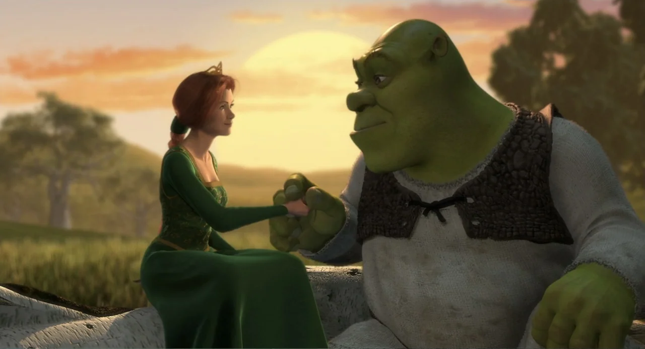 Shrek (2001) movie still: medium — A grassy field is illuminated by a setting sun behind distant hills and trees. An ogre and a human princess sit…