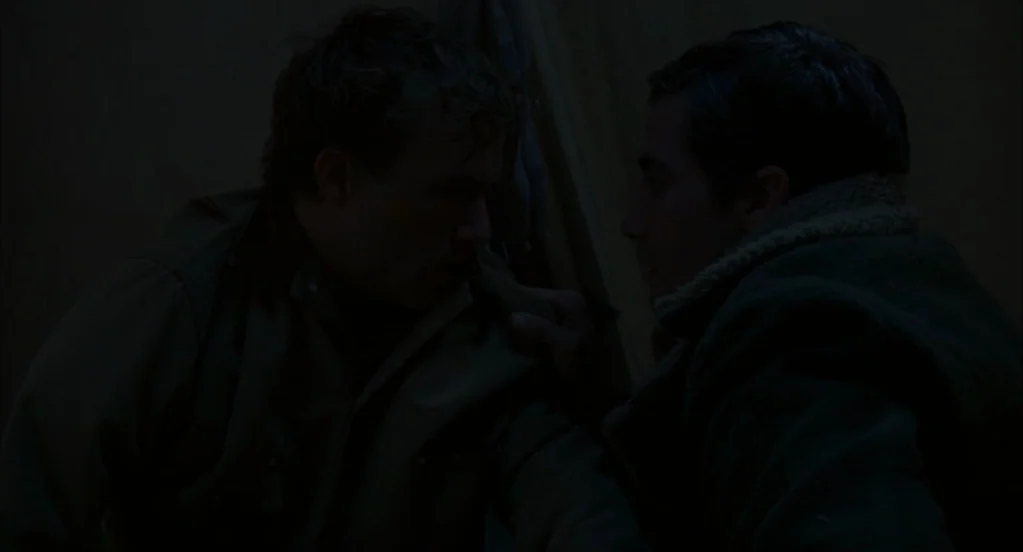 Brokeback Mountain (2005) movie still: medium — Two men sit face-to-face inside a dim, canvas-walled tent at night. The figures are partially…