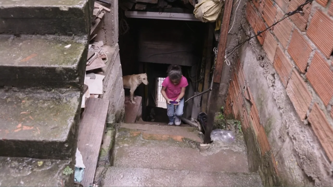 Finding the Way Home (1991) movie still: fullbody — An outdoor concrete staircase descends between a brick wall and a concrete ledge. A young girl…