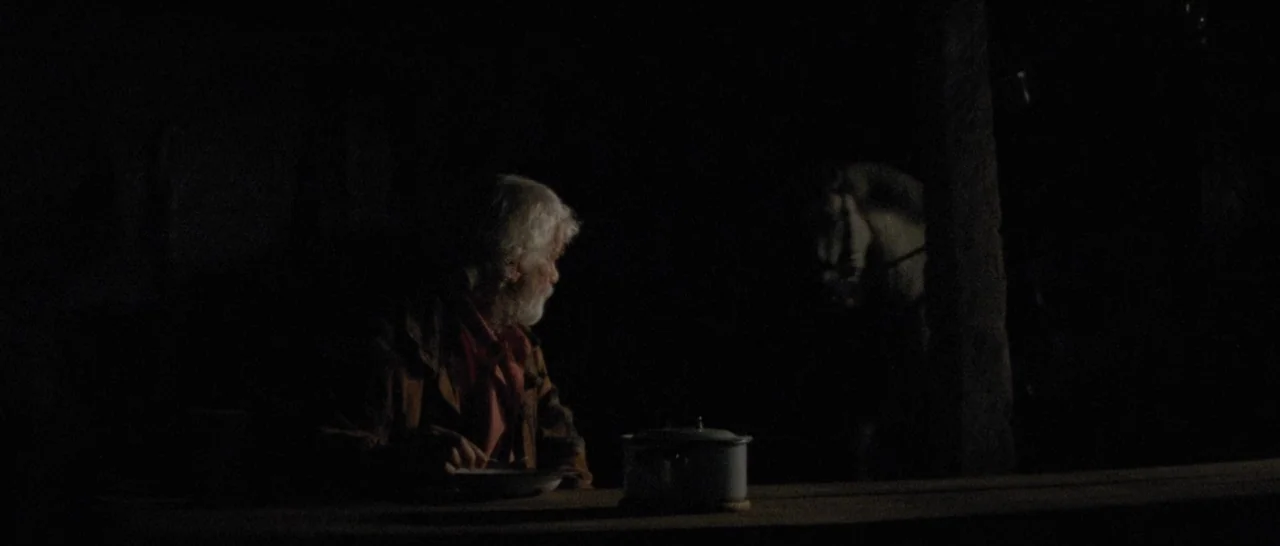 Arabian Nights: Volume 2 The Desolate One (2015) movie still: medium — A dark, rustic interior space with wooden textures and minimal ambient light.…