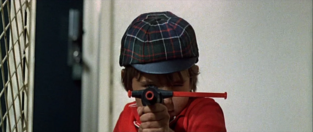 Two or Three Things I Know About Her (2 ou 3 choses que je sais d’elle) (1967) movie still: closeup — A plain interior corridor features a white…