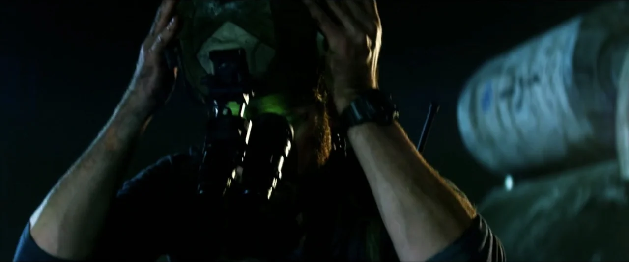 13 Hours: The Secret Soldiers of Benghazi (2016) movie still: closeup — A dark, confined space with mechanical equipment visible in the blurred…