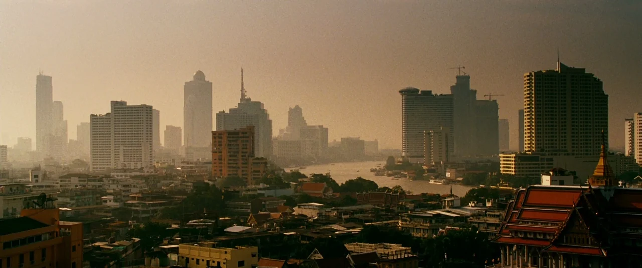 The Hangover Part II (2011) movie still: establishing — A dense urban skyline features numerous skyscrapers and lower residential buildings along a…