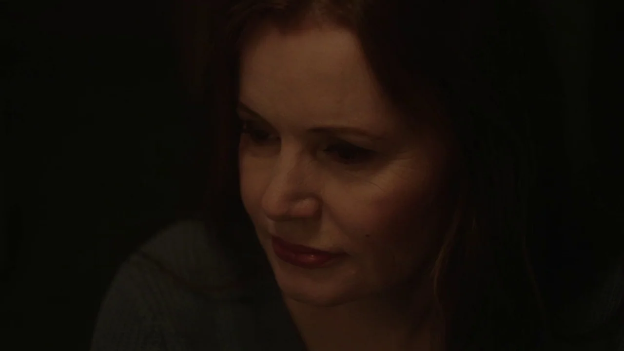 Marjorie Prime (2017) movie still: closeup — An interior space with very low light levels and indistinct background. A woman with shoulder-length…