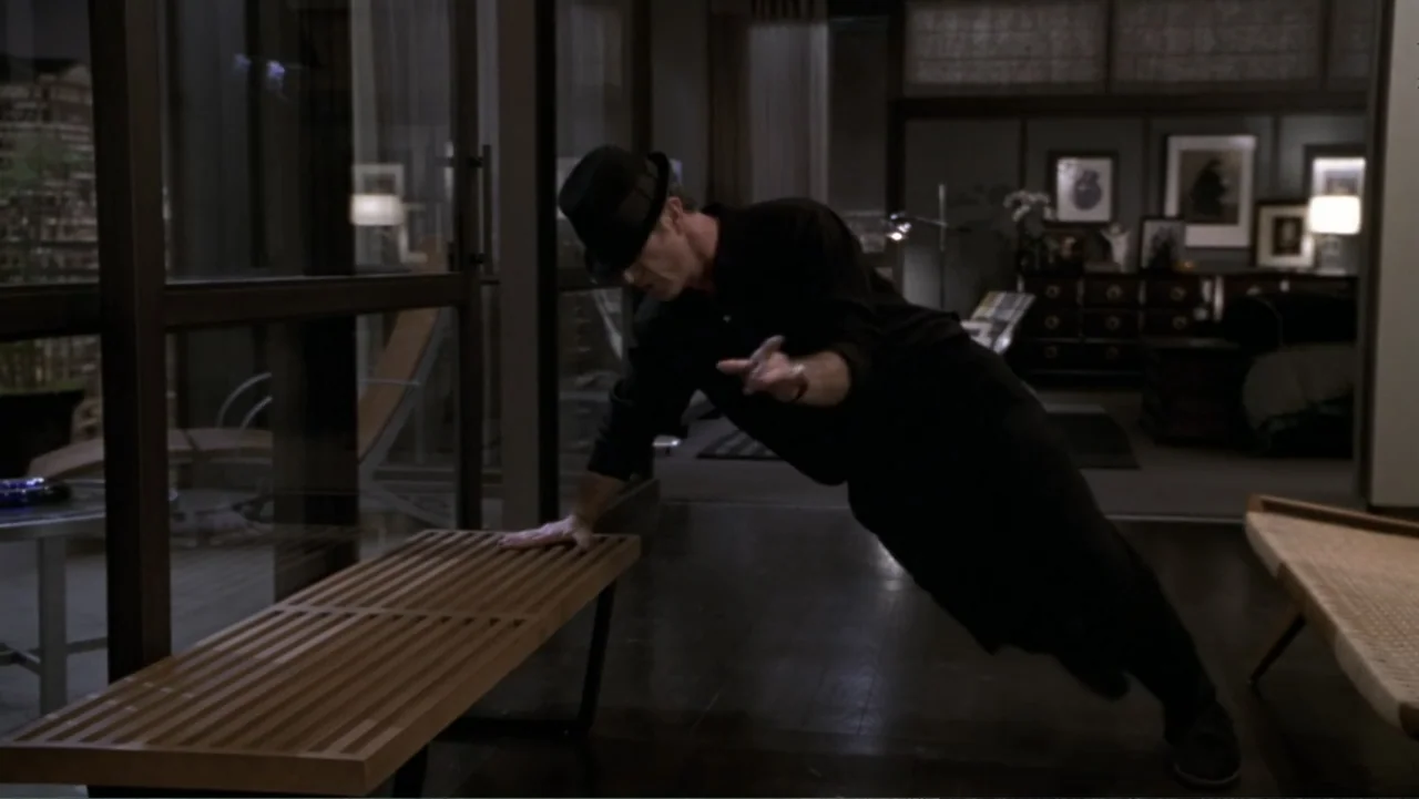 What Women Want (2000) movie still: fullbody — A dimly lit, contemporary open-plan apartment with dark hardwood floors and floor-to-ceiling windows.…