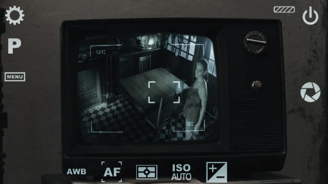 Still Life (2013) movie still: medium — A dim room features a checkerboard floor and a central square wooden dining table. A young woman stands…