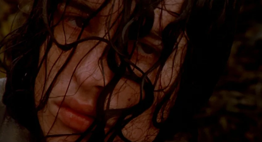 The Secret Of Roan Inish (1994) movie still: closeup — A close portrait of a young person in a dark outdoor environment. Wet hair falls across their…