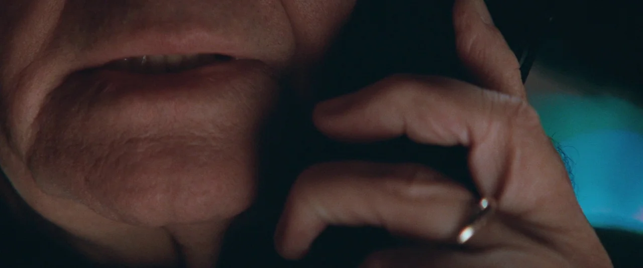The Sweet Hereafter (1997) movie still: closeup — A close view shows an older man's mouth and hand while on the phone. The background is mostly…