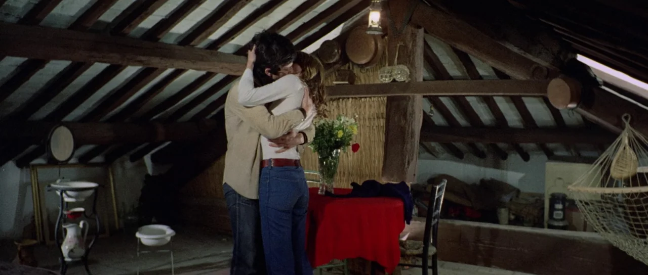 What Have They Done To Your Daughters? (1974) movie still: fullbody — An attic space features exposed wooden beams and a low sloped ceiling. A…
