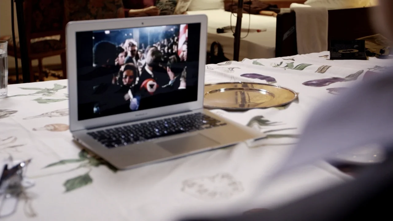 Breslin and Hamill: Deadline Artists (2018) movie still: medium — A white tablecloth with floral patterns covers a dining table in a quiet room. A…