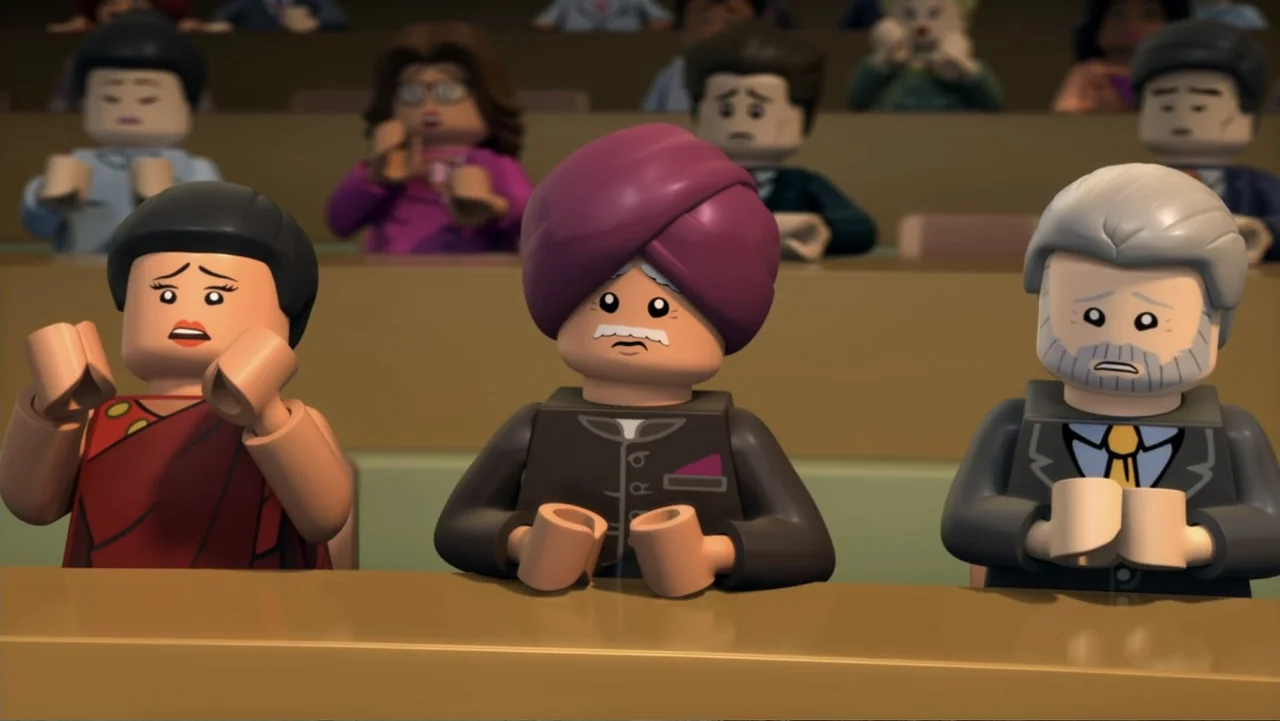 LEGO DC Comics Super Heroes: Justice League - Attack of the Legion of Doom! (2015) movie still: medium — A group of lego figures sit at desks inside…