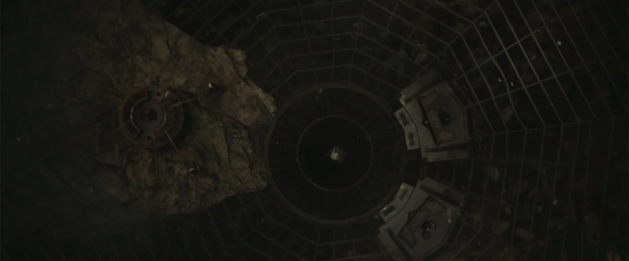 Along with the Gods: The Two Worlds (2017) movie still: establishing — A vast circular underground chamber features a central abyss surrounded by a…