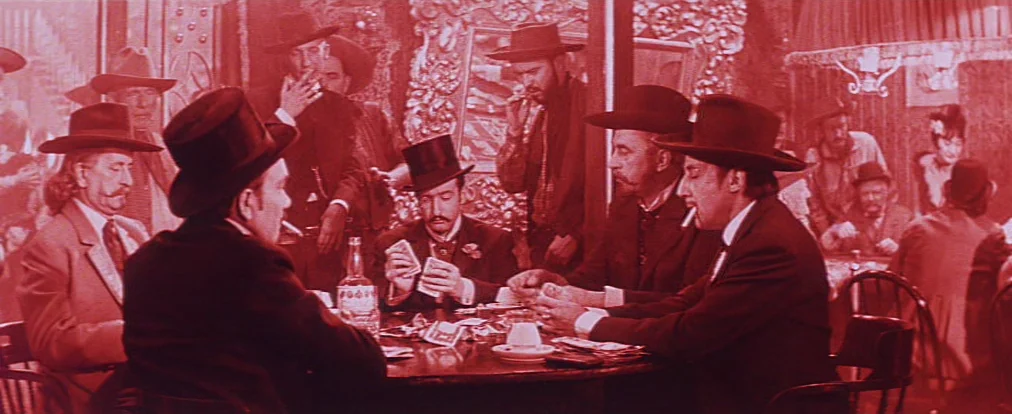 Lemonade Joe (1964) movie still: medium — A crowded 19th-century western saloon features several men playing a card game. Multiple subjects in…