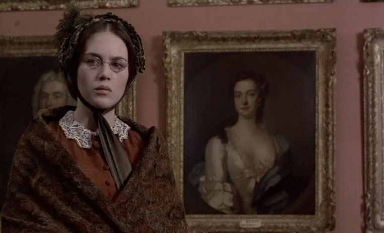 The Story of Adele H (1975) movie still: medium — A wall in a museum gallery is covered with framed oil portrait paintings. A young woman stands in…
