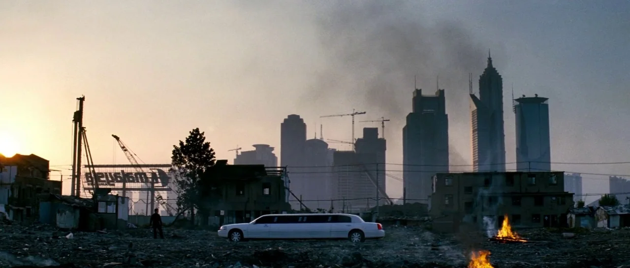 Mission: Impossible III (2006) movie still: wide — A vast, rubble-strewn wasteland sits at the foot of an urban skyline under construction. Dense…