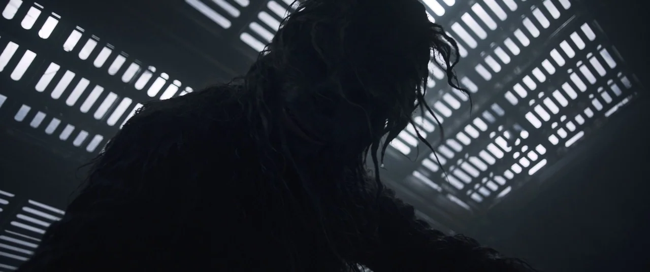 Solo: A Star Wars Story (2018) movie still: medium — A dark, metallic industrial corridor features a grid of rectangular recessed lighting panels…