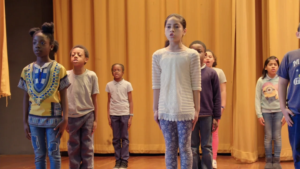 We Are the Dream: The Kids of the Oakland MLK Oratorical Fest (2020) movie still: fullbody — A group of diverse children stand in a row on a wooden…