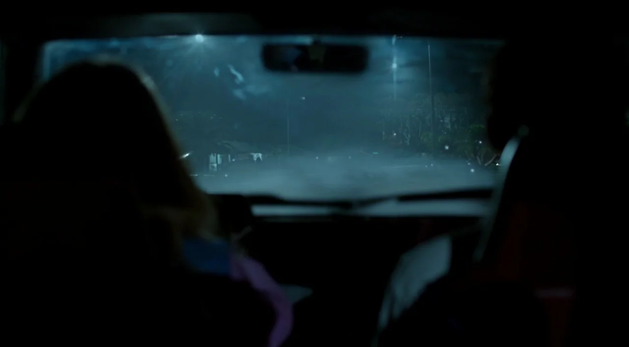 Miss Peregrine’s Home for Peculiar Children (2016) movie still: medium — The view from inside a car at night looking out at a dark street. Two…