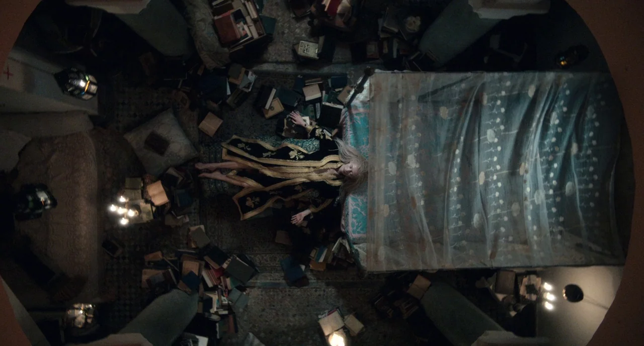 Only Lovers Left Alive (2013) movie still: fullbody — An opulent chamber with stone floors is cluttered with numerous scattered hardcover books. A…