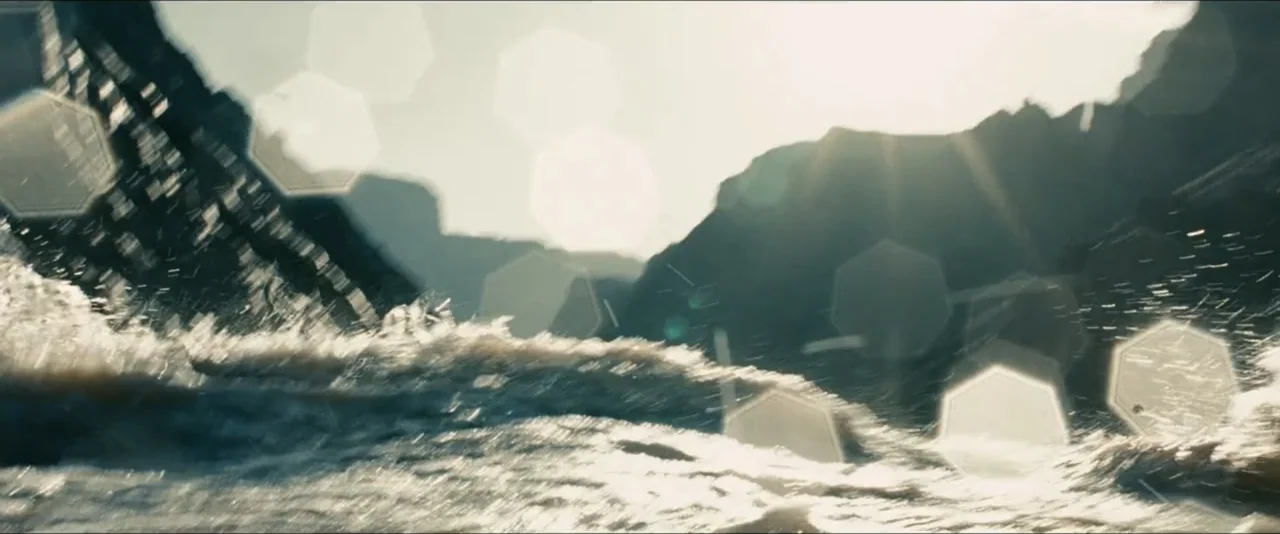 Into the Wild (2007) movie still: establishing — A low-angle view captures a churning, turbulent river surface against a backdrop of steep cliffs.…