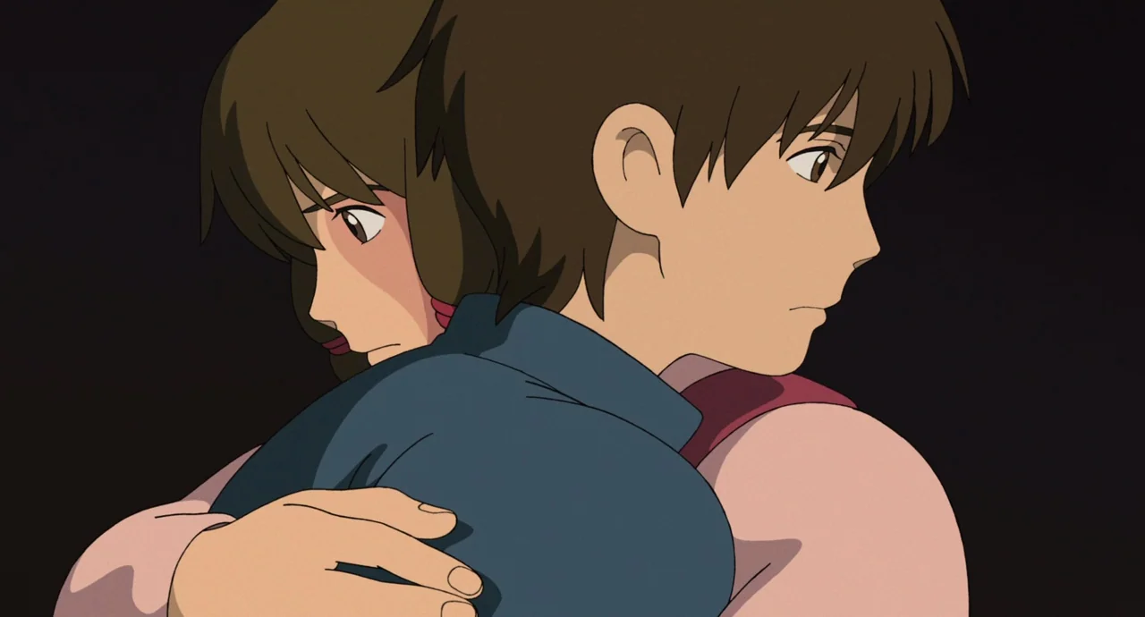 Tales From Earthsea (2006) movie still: closeup — Two characters embrace in a space with a solid black background. The boy and girl lean into each…