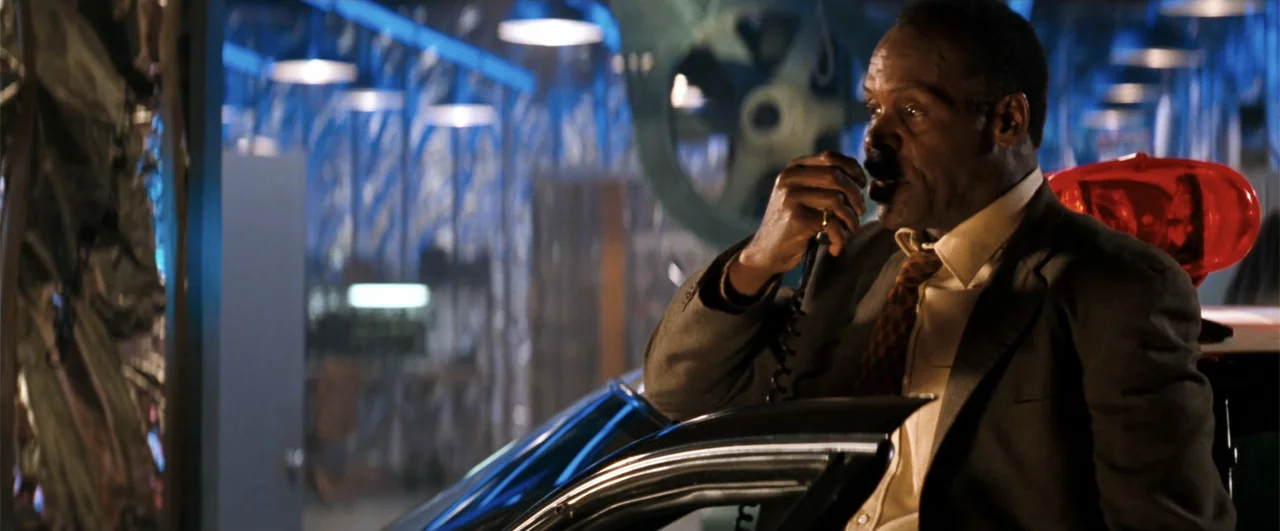 Lethal Weapon 4 (1998) movie still: medium — A dark parking garage at night filled with industrial steel supports and car fixtures. An older man…